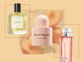 Three perfume bottles arranged with a peach background
