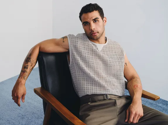 Mason Gooding seated in a relaxed pose
