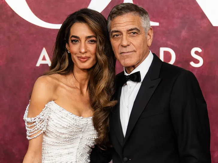 George Clooney and Amal Clooney posing together at an event